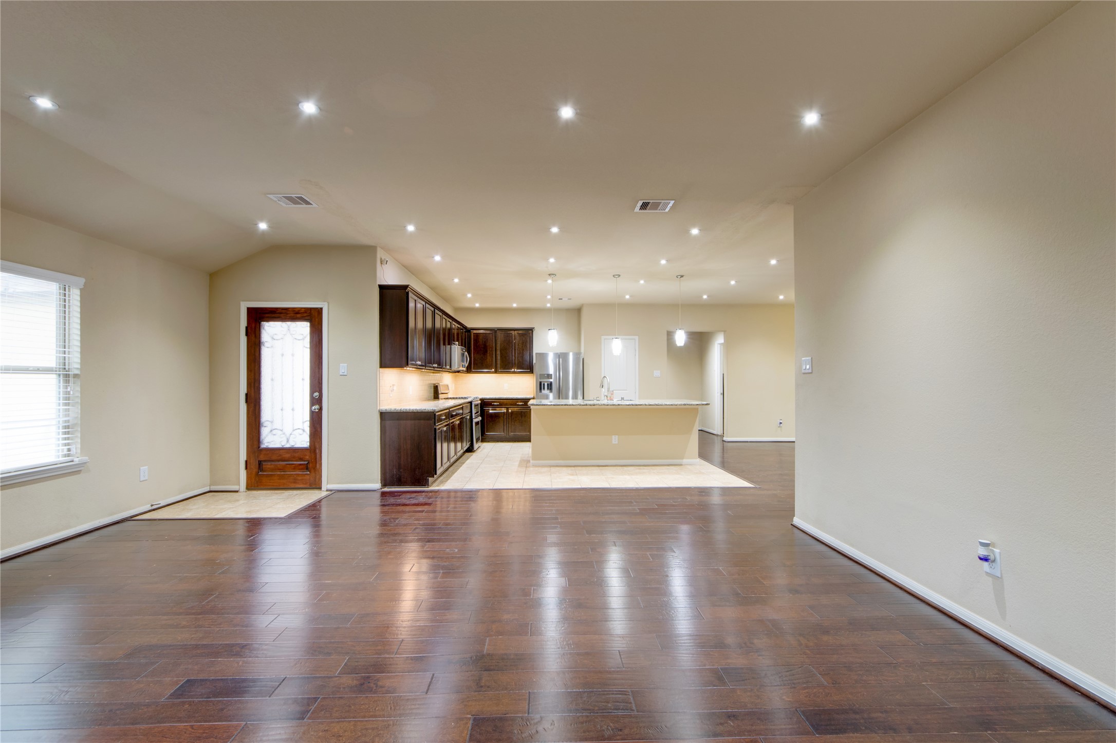 9322 Limestone Ranch Lane Richmond, TX 77407 - Photo 15 of 40 a view of a kitchen with a sink cabinets and wooden floor
