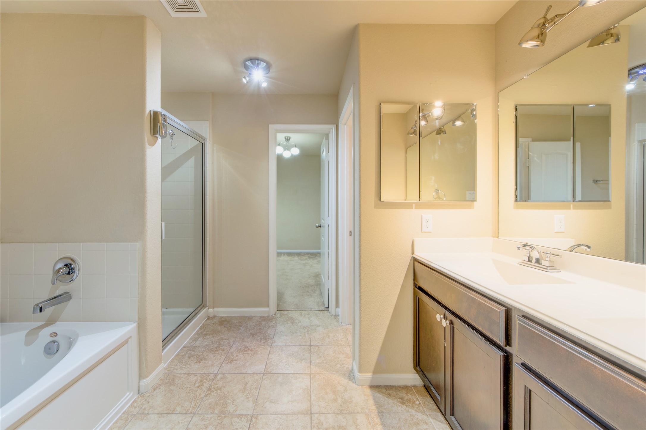 9322 Limestone Ranch Lane Richmond, TX 77407 - Photo 21 of 40 a bathroom with a sink a mirror and a bathtub