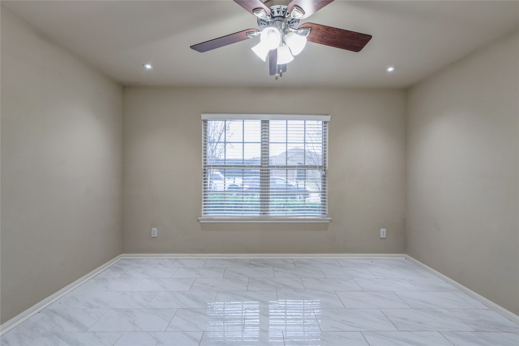 9322 Limestone Ranch Lane Richmond, TX 77407 - Photo 28 of 40 an empty room with a chandelier fan and windows