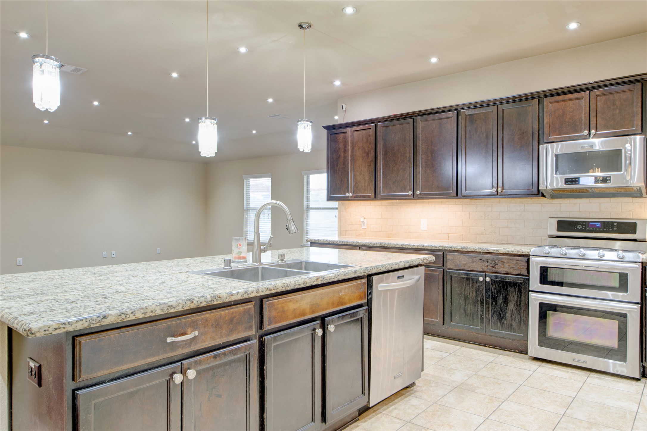 9322 Limestone Ranch Lane Richmond, TX 77407 - Photo 8 of 40 a kitchen with a sink stainless steel appliances and cabinets