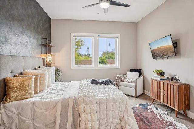 a bedroom with a bed and a potted plant