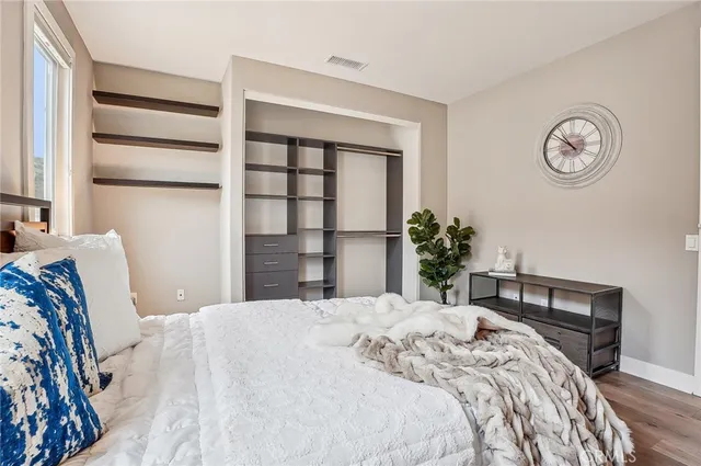 a bathroom with a granite countertop sink mirror and toilet
