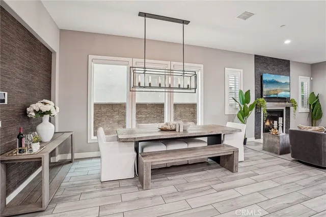 a living room with furniture windows and wooden floor