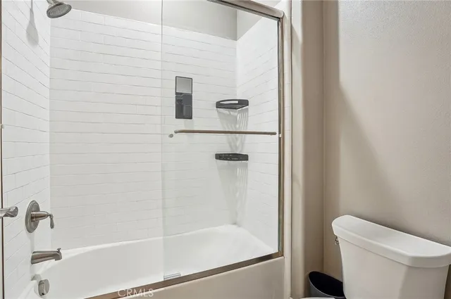 a bedroom with a bed and painting on the wall