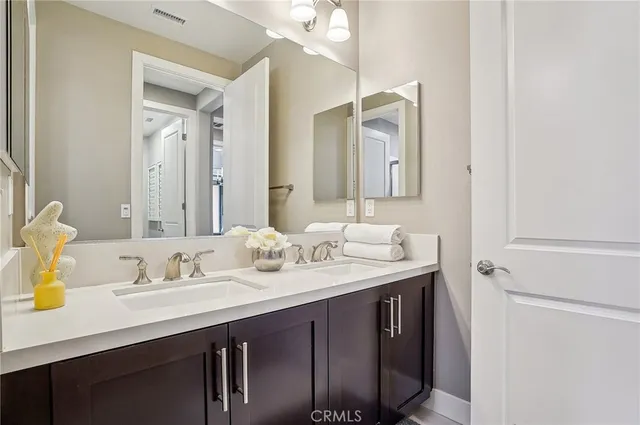 a bed sitting in a bedroom next to a window and a potted plant