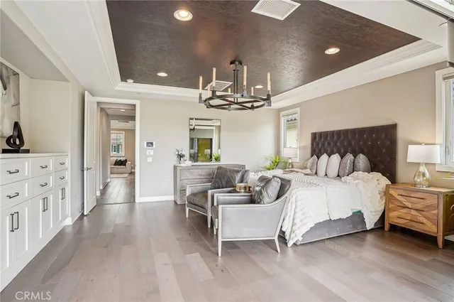 a bedroom with furniture and large windows