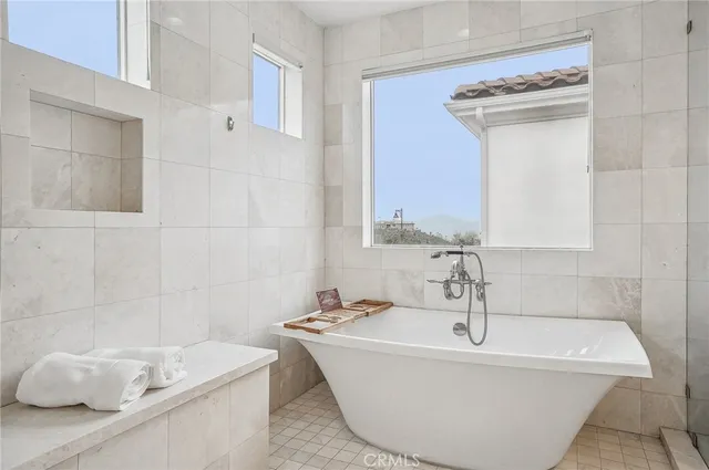 a spacious bathroom with a shower sink mirror and