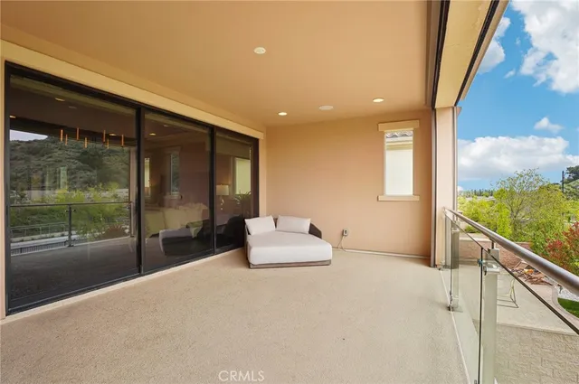 a view of a house with a swimming pool and sitting area