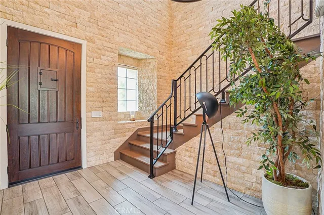 a view of entryway with wooden floor and stairs