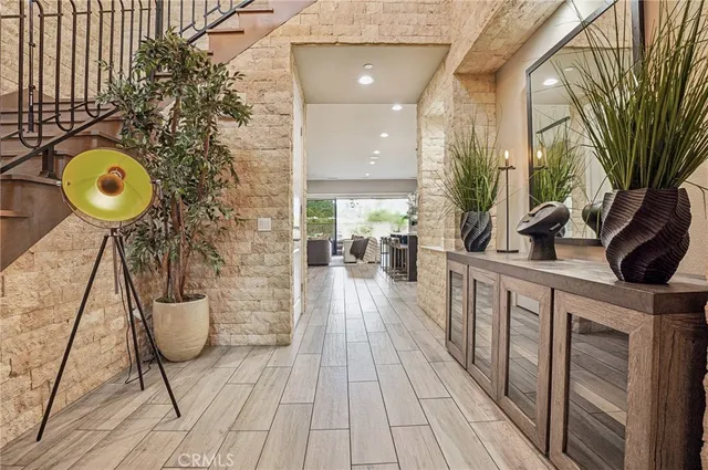 a view of a balcony with chairs and wooden floor