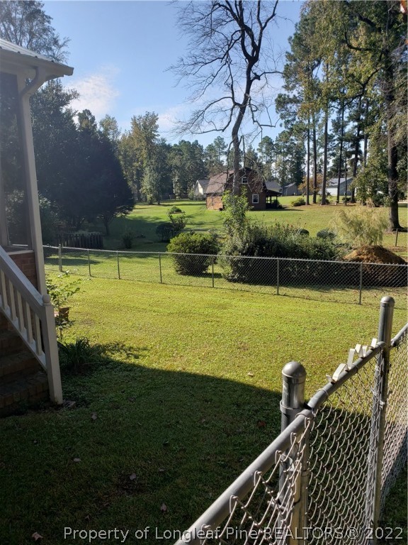 315 Old Farm Road Raeford, NC 28376 - Photo 4 of 13 a view of a large pool with lawn chairs and a table