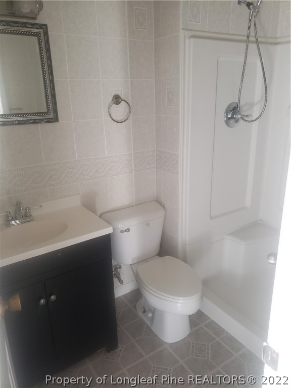 315 Old Farm Road Raeford, NC 28376 - Photo 5 of 13 a white toilet sitting next to a bathroom sink