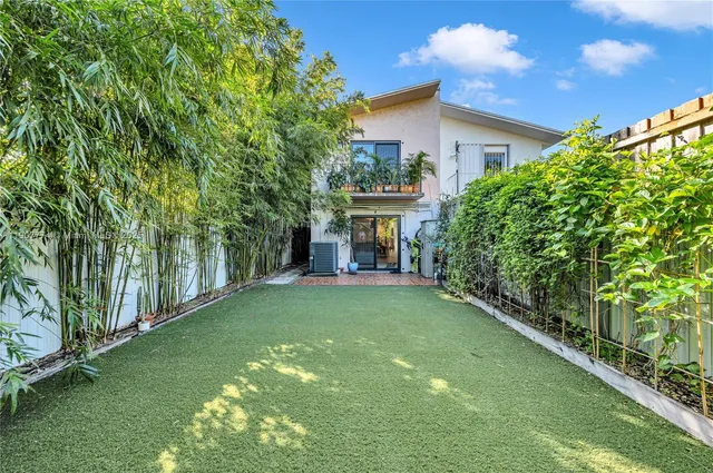 a view of house with backyard space and garden