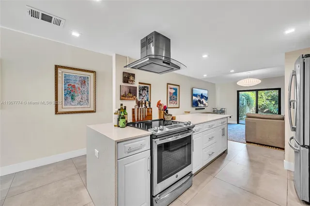 a kitchen with stainless steel appliances granite countertop a stove and a sink
