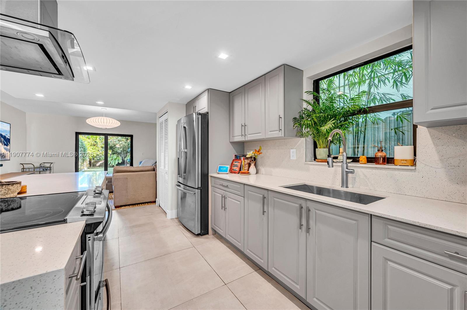 2965 Southwest 25th Terrace, Unit 2965 Miami, FL 33133 - Photo 13 of 40 a kitchen with a sink appliances and windows
