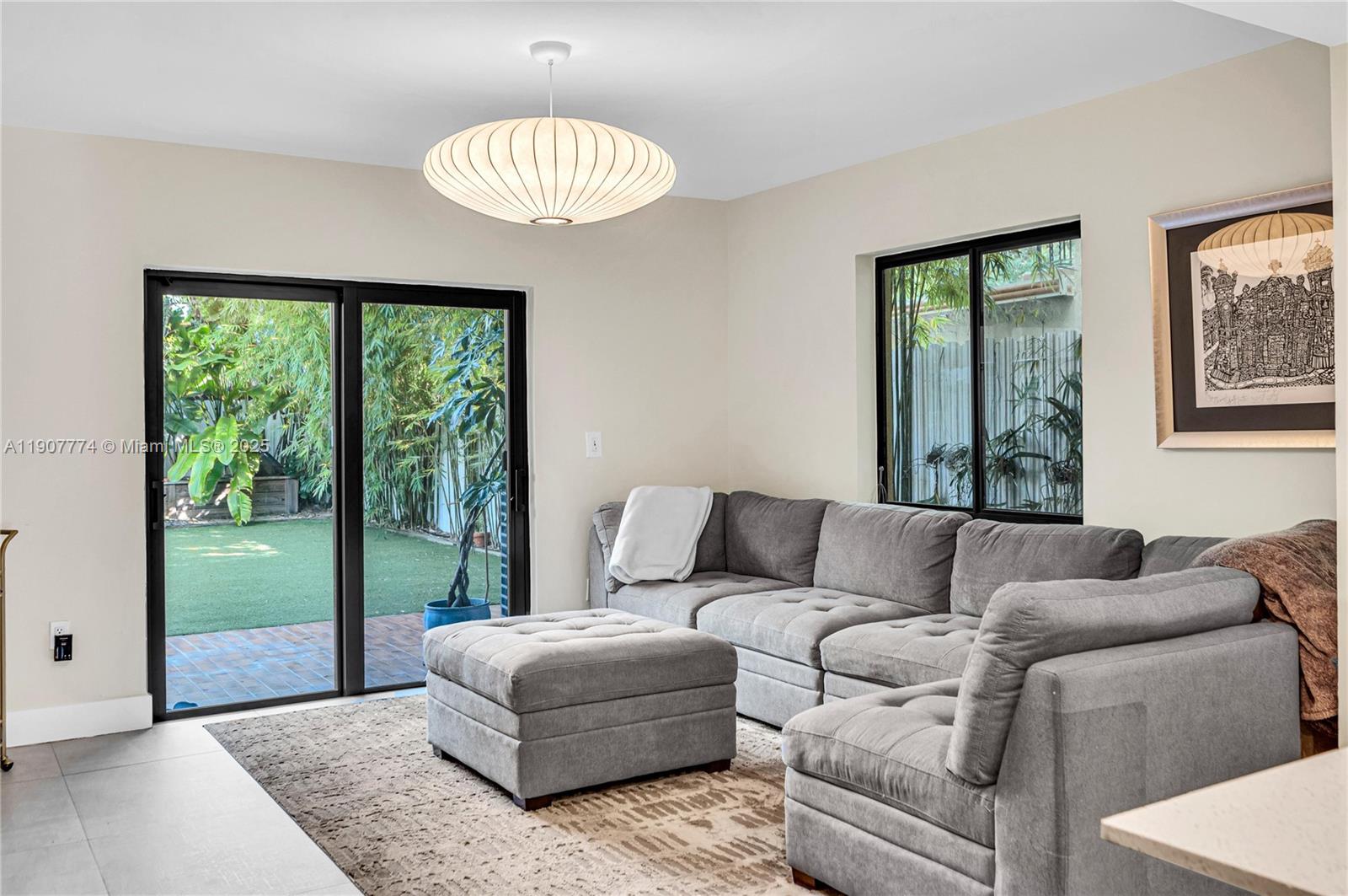 2965 Southwest 25th Terrace, Unit 2965 Miami, FL 33133 - Photo 16 of 40 a living room with furniture and a large window