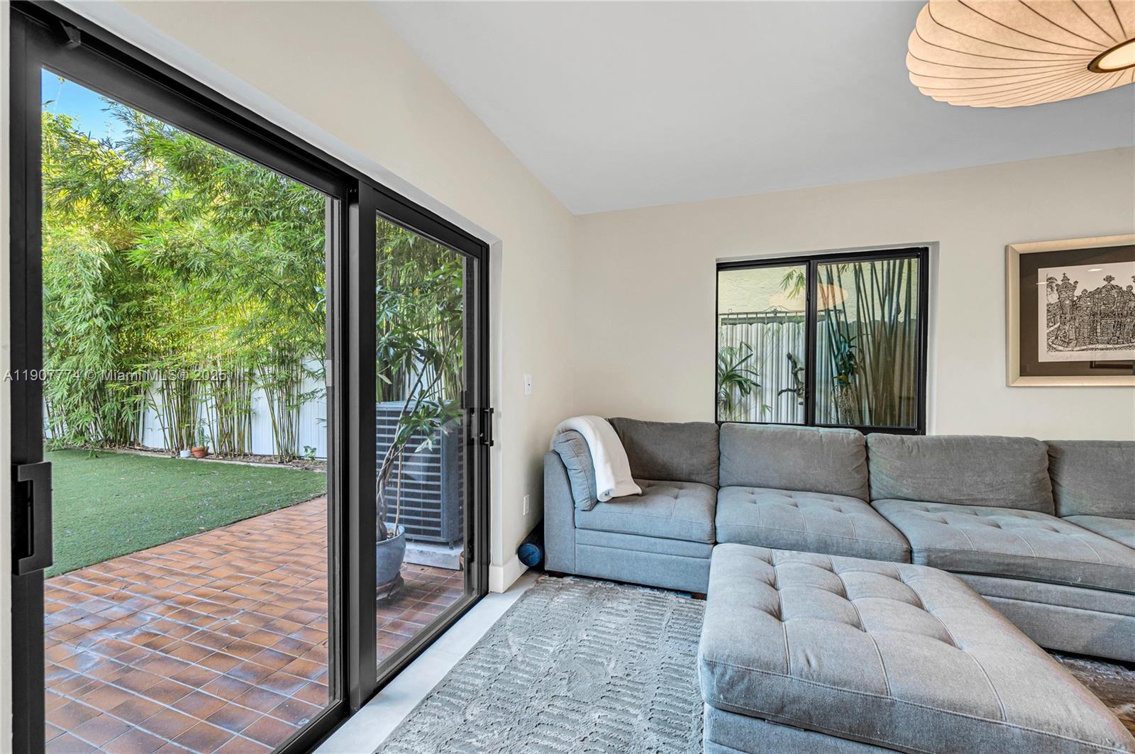 2965 Southwest 25th Terrace, Unit 2965 Miami, FL 33133 - Photo 18 of 40 a living room with furniture and a large window