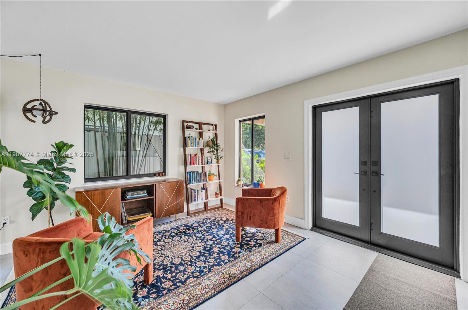 2965 Southwest 25th Terrace, Unit 2965 Miami, FL 33133 - Photo 2 of 40 a living room with patio furniture and a potted plant