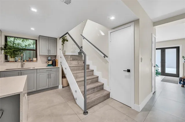 a view of entryway and kitchen with wooden floor