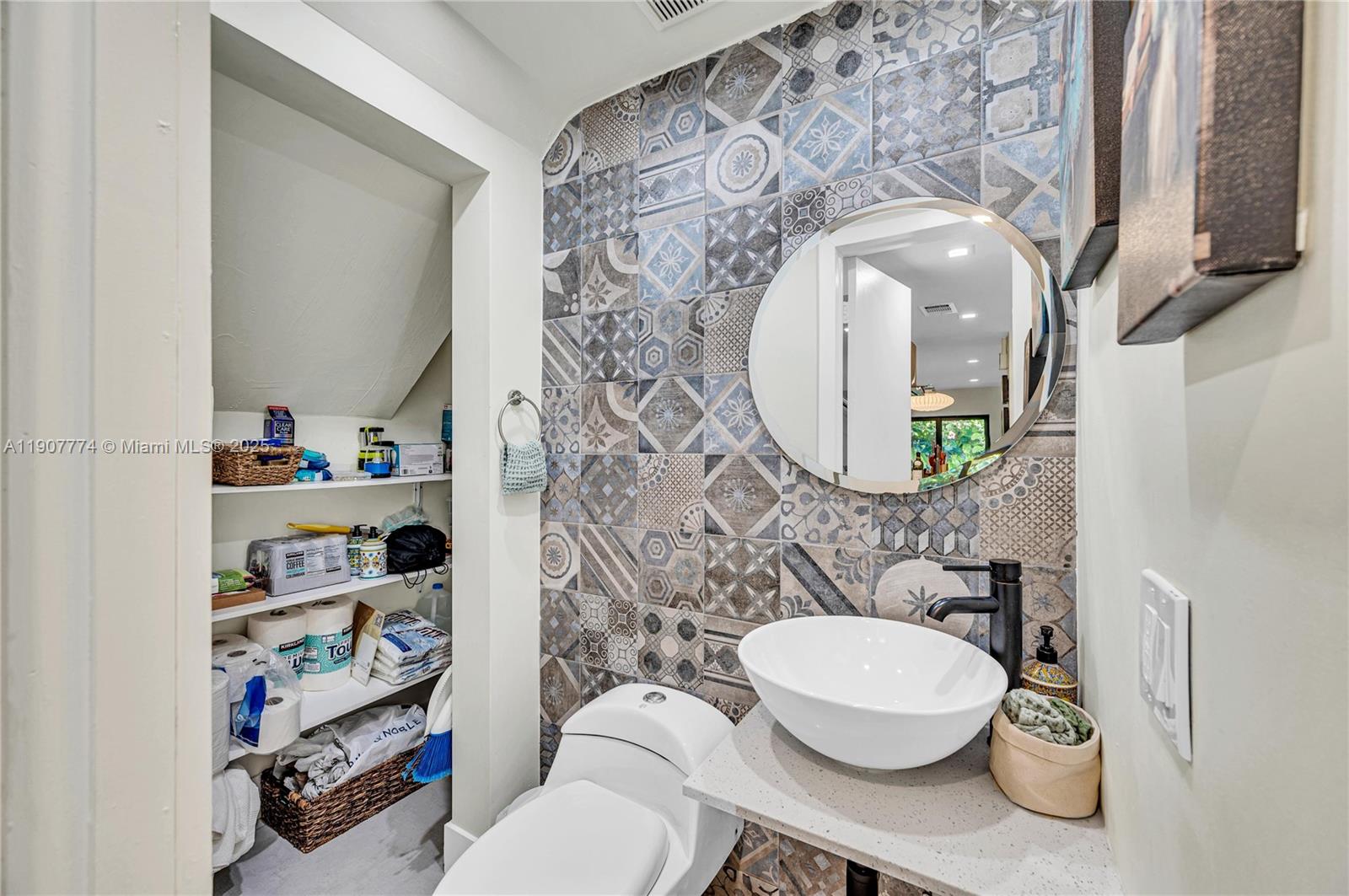 2965 Southwest 25th Terrace, Unit 2965 Miami, FL 33133 - Photo 23 of 40 a bathroom with a toilet a sink and a mirror