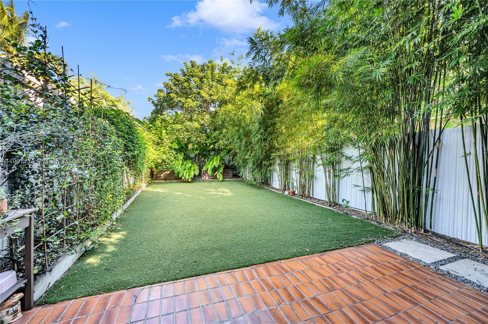 2965 Southwest 25th Terrace, Unit 2965 Miami, FL 33133 - Photo 24 of 40 a view of a backyard with large trees