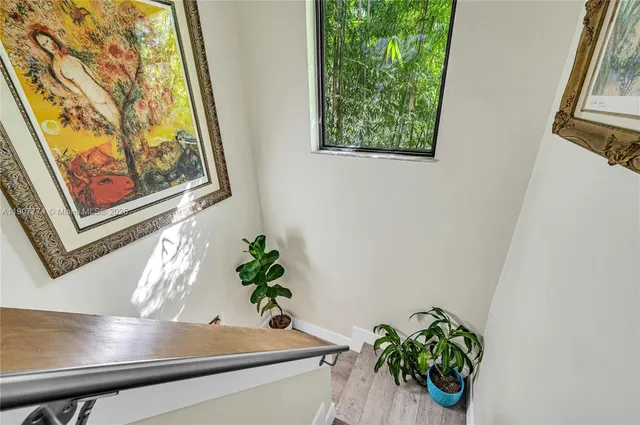 a vase of flowers sitting on a table with a window