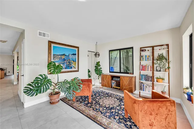 a living room with furniture and a potted plant