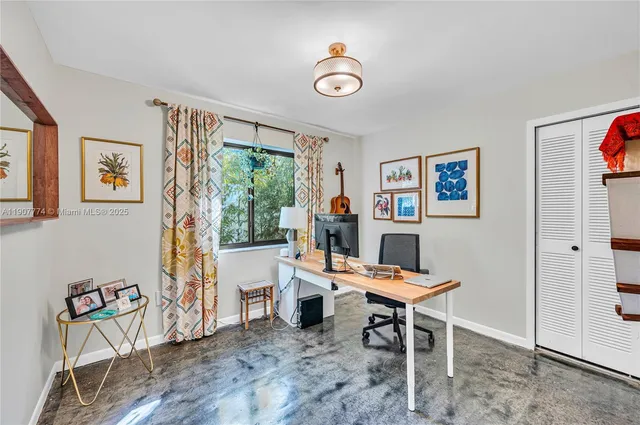 a work room with furniture and a window