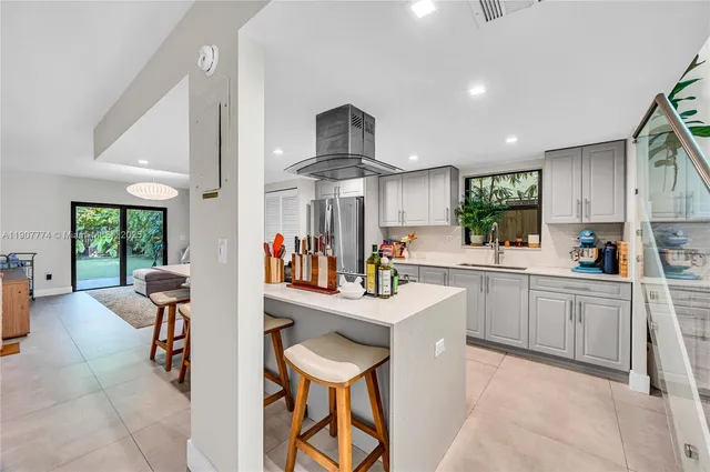 a kitchen with stainless steel appliances kitchen island granite countertop a sink and cabinets