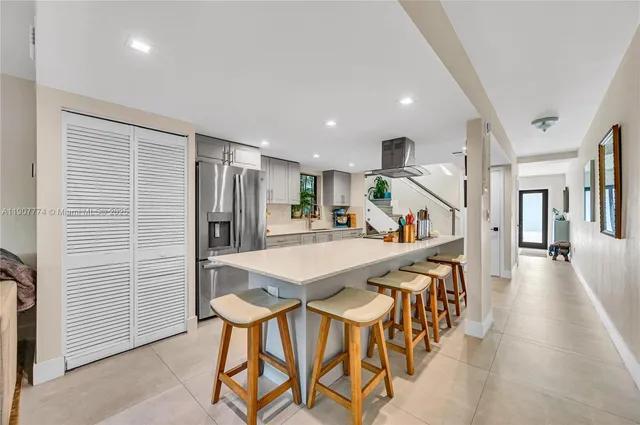a view of a dining area with furniture and a kitchen