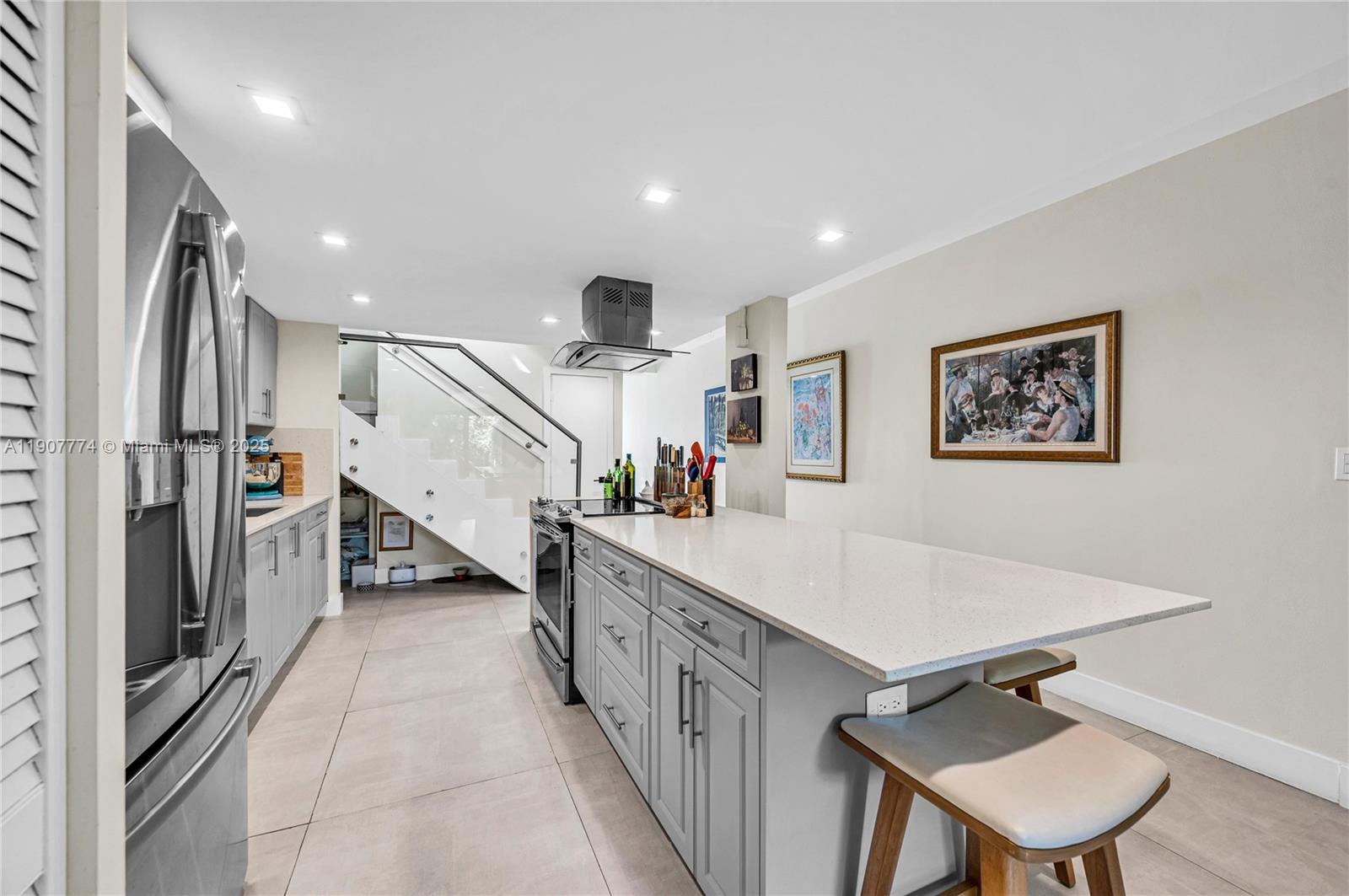 2965 Southwest 25th Terrace, Unit 2965 Miami, FL 33133 - Photo 10 of 40 a large white kitchen with a sink a refrigerator and a stove