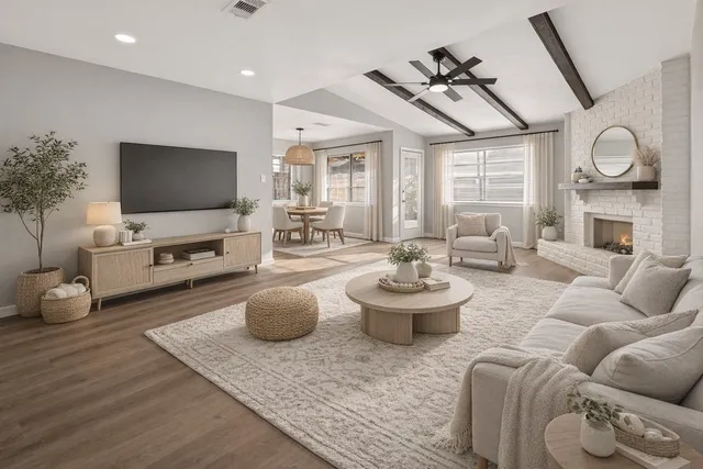 a living room with furniture a rug and a flat screen tv