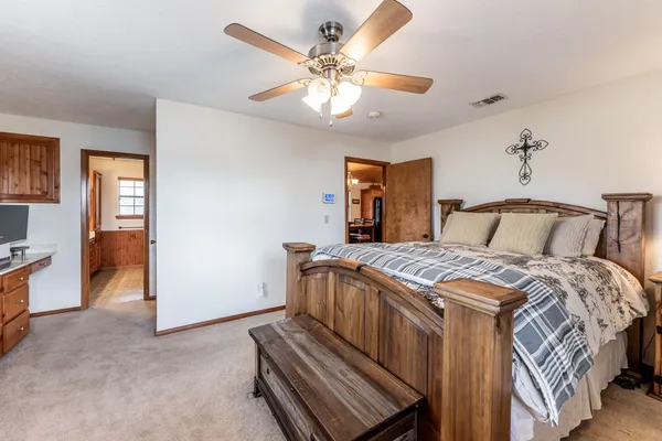 a bedroom with a bed and a chandelier