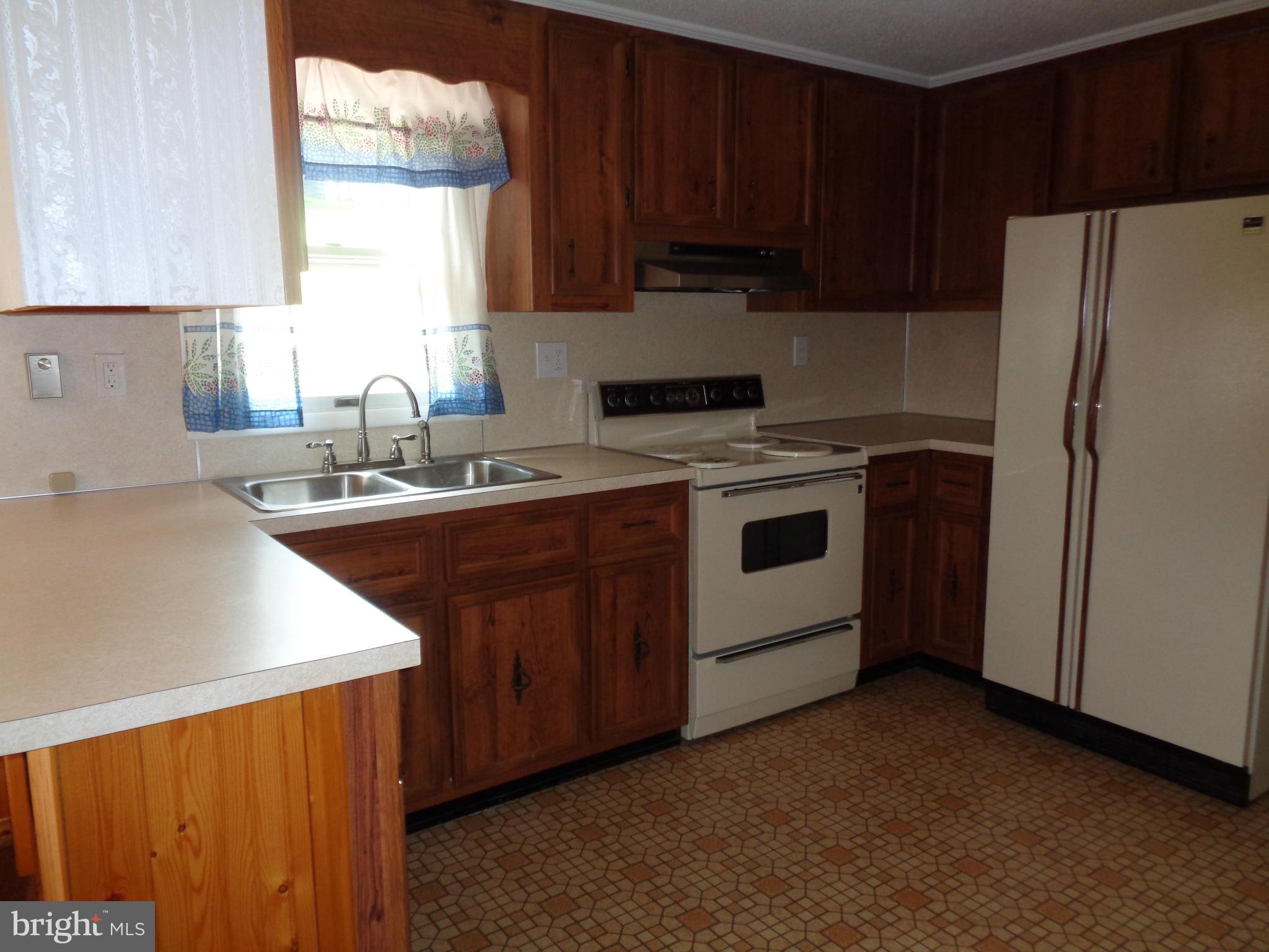 4307 York Road, Unit 1 Manchester, MD 21102 - Photo 19 of 30 a kitchen with a sink a stove a refrigerator and cabinets