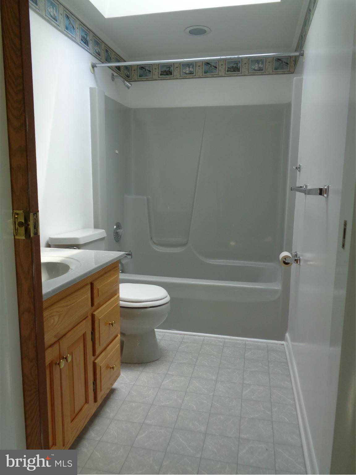 4307 York Road, Unit 1 Manchester, MD 21102 - Photo 26 of 30 a bathroom with a granite countertop sink toilet and shower