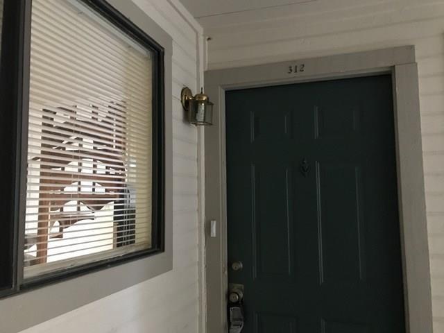 2500 Burleson Road, Unit 312 Austin, TX 78741 - Photo 6 of 6 A welcoming entry, complete with exterior lighting and a large window, provides a peek into the home.