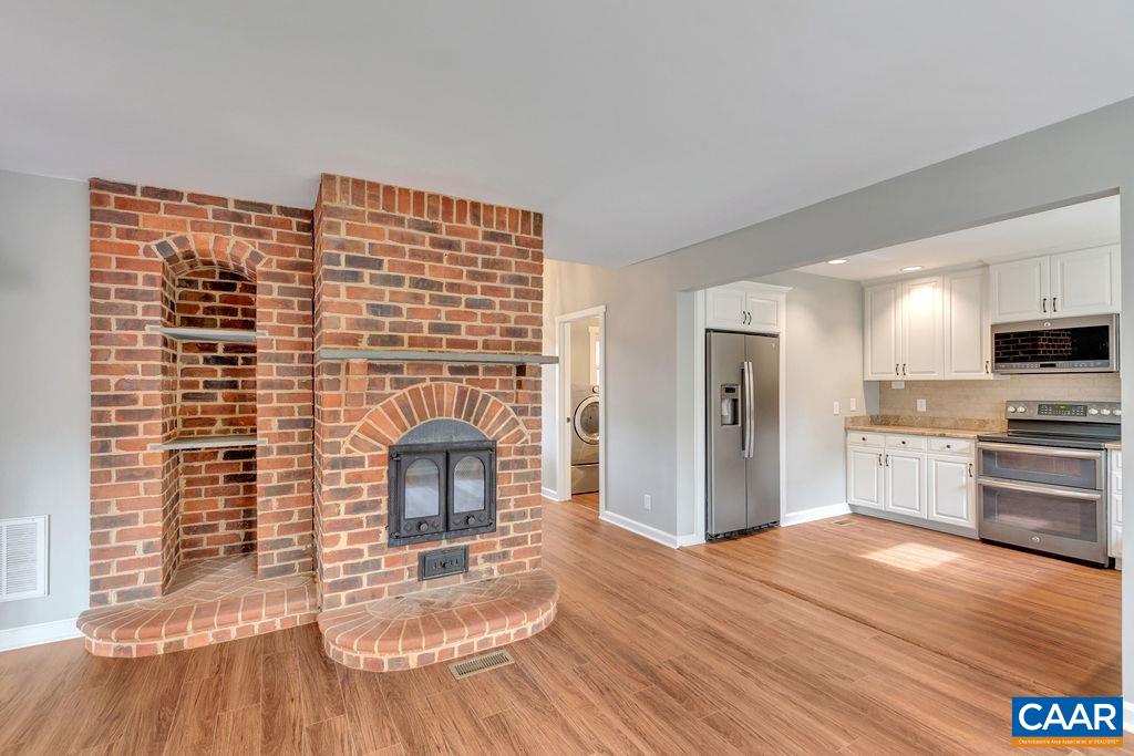 1900 Thunder Ridge Road Afton, VA 22920 - Photo 21 of 49 a living room with stainless steel appliances kitchen island granite countertop a refrigerator stove oven and white cabinets with wooden floor