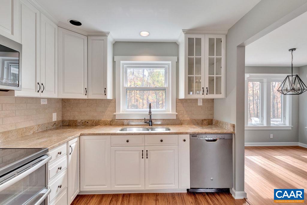 1900 Thunder Ridge Road Afton, VA 22920 - Photo 24 of 49 a kitchen with granite countertop white cabinets and white appliances