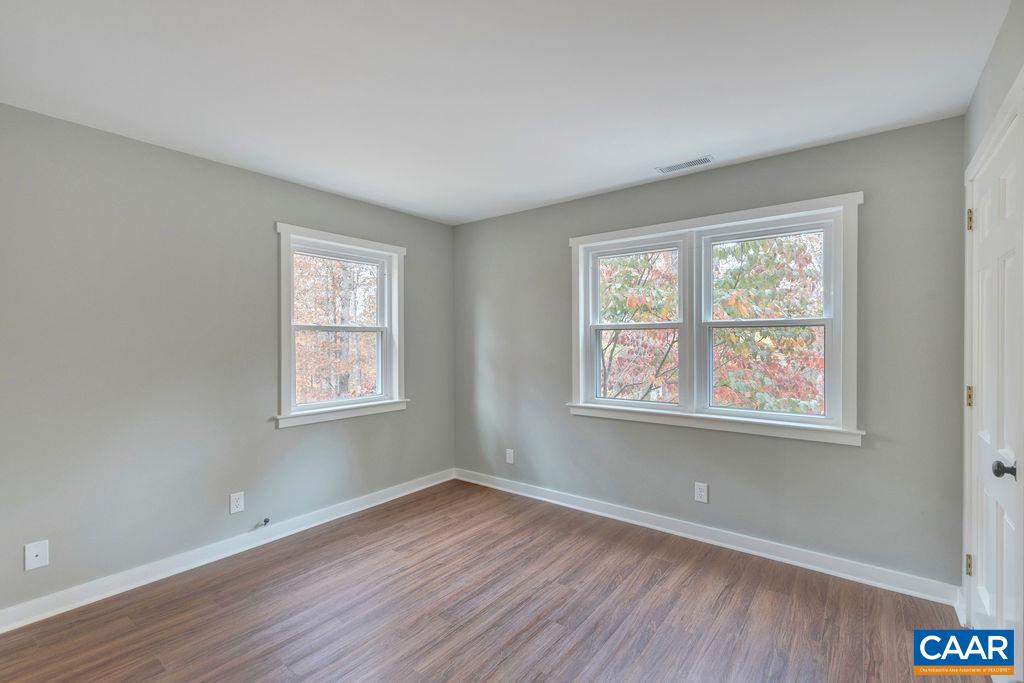 1900 Thunder Ridge Road Afton, VA 22920 - Photo 28 of 49 a view of an empty room with wooden floor and a window