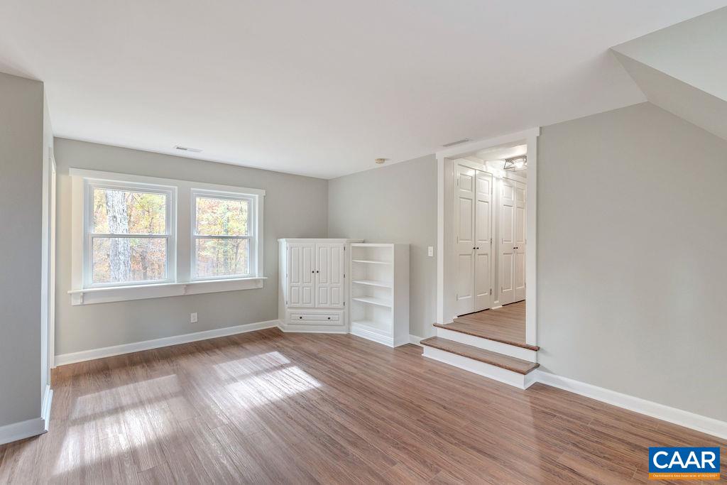 1900 Thunder Ridge Road Afton, VA 22920 - Photo 32 of 49 an empty room with wooden floor and windows
