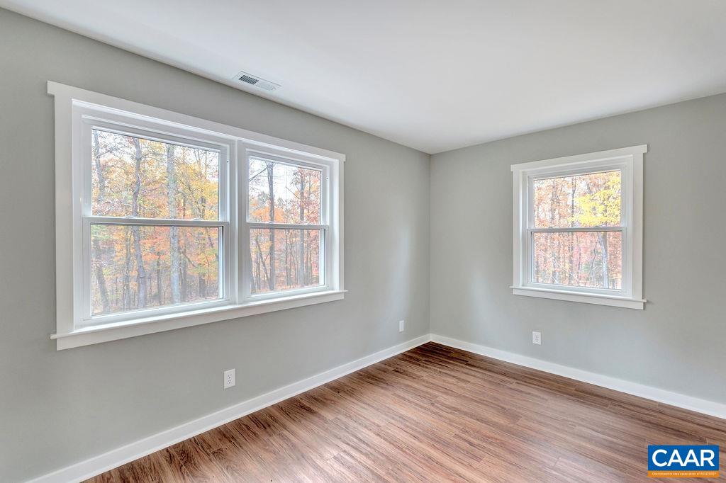 1900 Thunder Ridge Road Afton, VA 22920 - Photo 36 of 49 a view of an empty room with wooden floor and a window