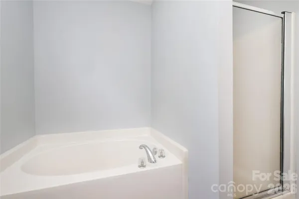 a white bath tub and shower