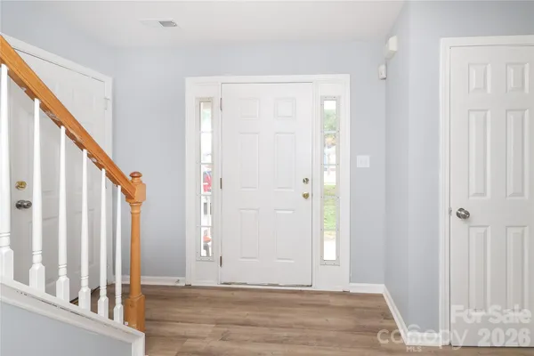 an entryway with wooden floor
