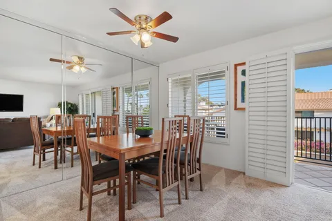 a view of a dining room with furniture and a chandelier