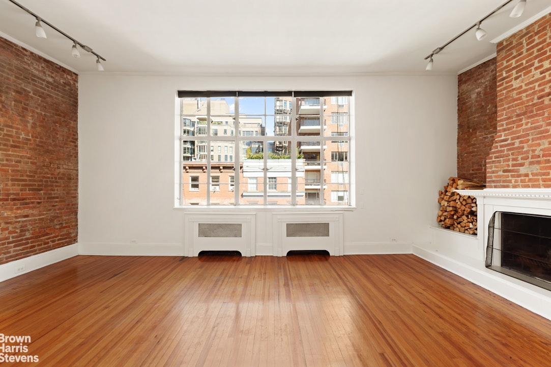 20 West 12th Street Manhattan, NY 10011 - Photo 25 of 30 an empty room with wooden floor and windows