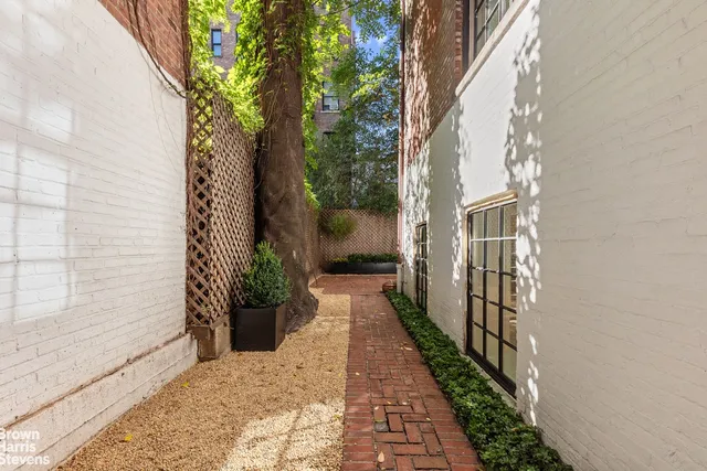a view of a pathway both side of house