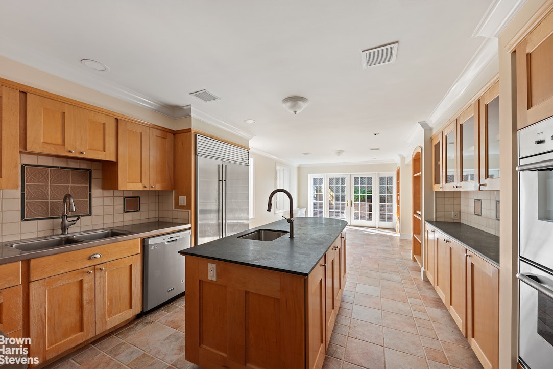 20 West 12th Street Manhattan, NY 10011 - Photo 9 of 30 a kitchen with stainless steel appliances granite countertop a sink stove and cabinets