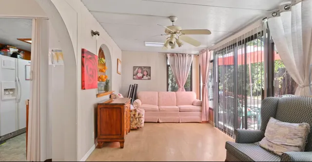 a bedroom with furniture and a large window
