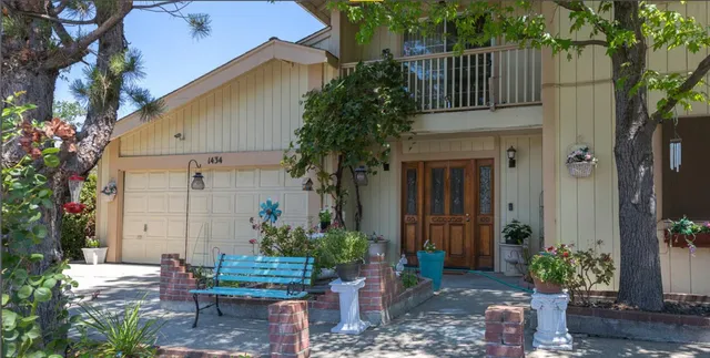 a front view of a house with garden