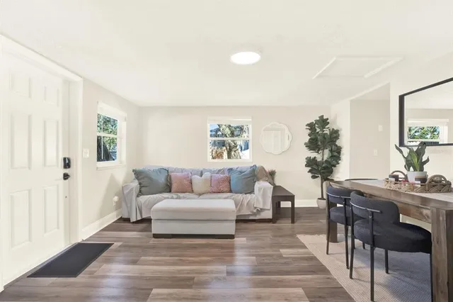 a living room with furniture and wooden floor